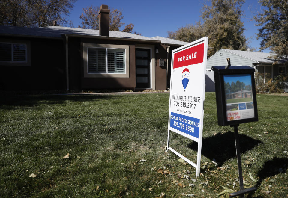 FILE - In this Oct. 22, 2019, file photo a sign stands outside a home for sale in southeast Denver. On Wednesday, Nov. 27, Freddie Mac reports on this week’s average U.S. mortgage rates. (AP Photo/David Zalubowski, File)