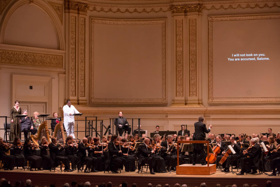In this May 24, 2012, provided by Carnegie Hall, Swedish soprano Nina Stemme, left, sings in the title role of Salome with Eric Owens, wearing white, perfoming as Jochanaan with the Cleveland Orchestra at Carnegie Hall in New York. (AP Photo/Carnegie Hall, Chris Lee)