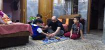 Local worker Mohammed Haider plays with his children at his home in Basra