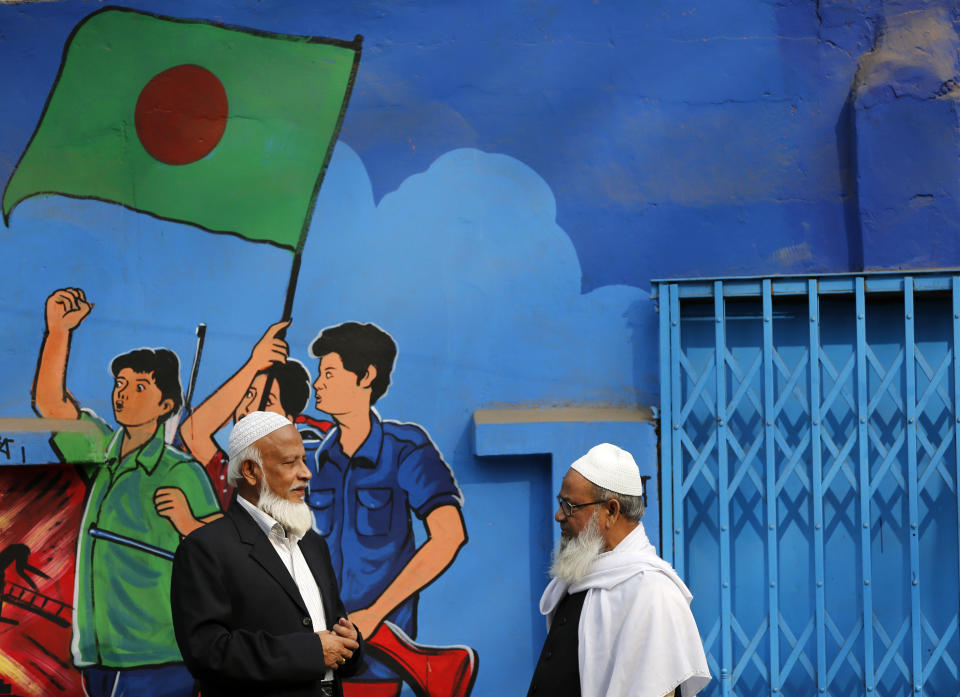 Bangladeshi Muslims talk outside a polling station after casting their votes in Dhaka, Bangladesh, Sunday, Jan. 5, 2014. Police in Bangladesh fired at protesters and more than 100 polling stations were torched in Sunday’s general elections marred by violence and a boycott by the opposition, which dismissed the polls as a farce. (AP Photo/Rajesh Kumar Singh)