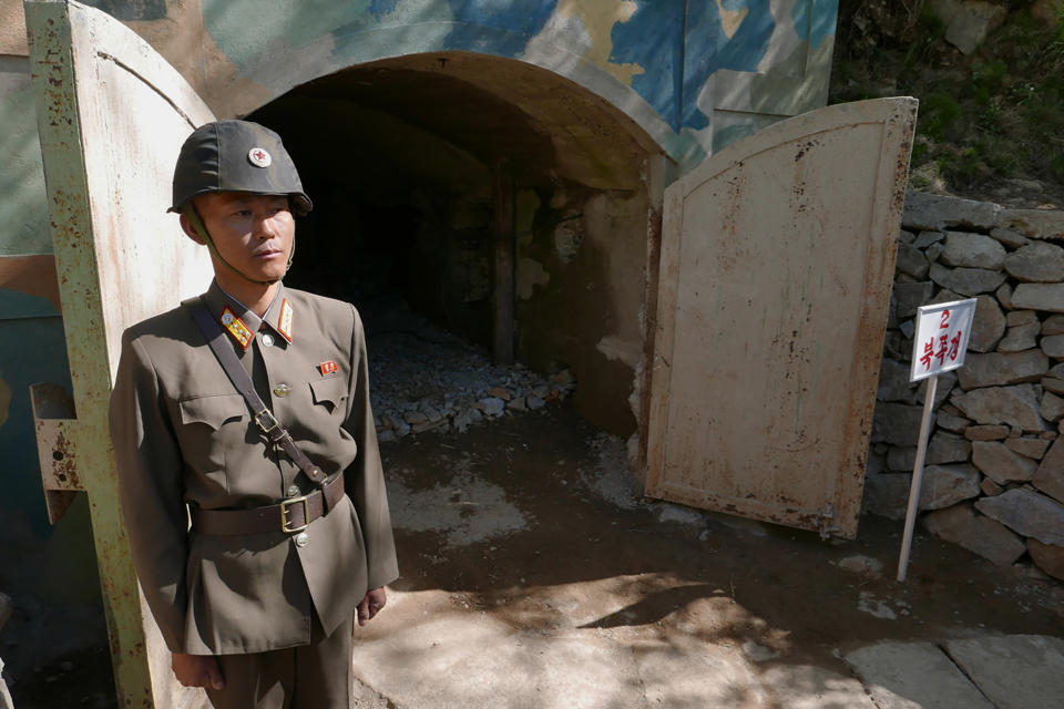 FILE - A guard stands at the entrance of the north tunnel at North Korea's nuclear test site shortly before it was to be blown up in a media tour of dismantling the test site, at Punggye-ri, North Hamgyong Province, North Korea, on May 24, 2018. Human rights advocates on Tuesday, Feb. 21, 2023, urged South Korea to offer radiation exposure tests to hundreds of North Korean escapees who had lived near the country’s nuclear testing ground. (APTN via AP, File)