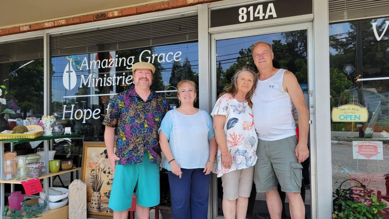 Amazing Grace Ministries Vintage and Thrift Shoppe owners Darrell and Cora Tharp, right, are keeping their store open, thanks to a new partnership with David Bryson, far left, and Kelly Weavil, second from left.