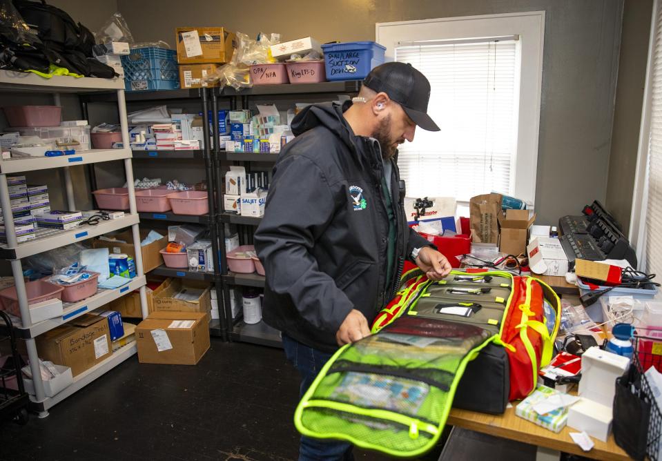 CAHOOTS emergency crisis worker Matt Eads checks his medical kit after a shift in Eugene.