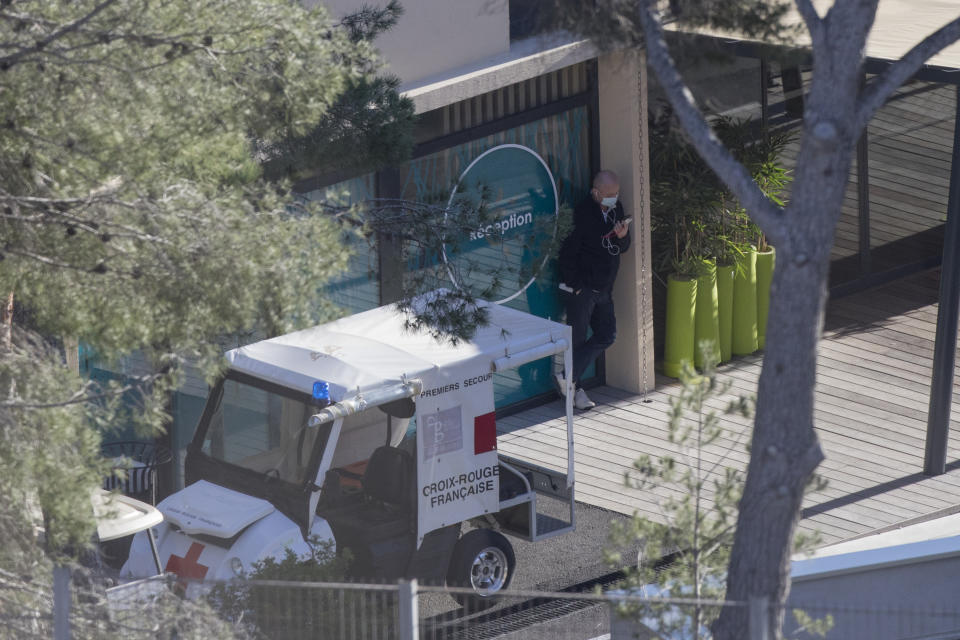 A person wearing a mask is pictured at a complex used as a quarantined vacation center in Carry-le-Rouet, southern France, which is currently accommodating French citizens repatriated from the virus-hit city of Wuhan, Wednesday, Feb. 5, 2020. More than 20,000 people have been infected by the outbreak of a respiratory illness from the coronavirus in China. France has issued an advisory, warning against any non-essential travel to China and suggesting that French citizens who were already there return home. (AP Photo/Daniel Cole)