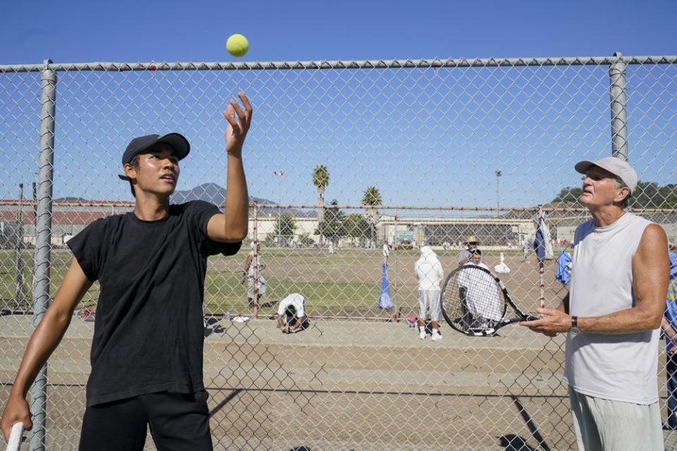 Stefan Schneider, left, shares advice on his serve technique with San Quentin State Prison inmate Kenny Rogers in San Quentin, Calif., Saturday, Aug. 13, 2022. (AP Photo/Godofredo A. Vásquez)