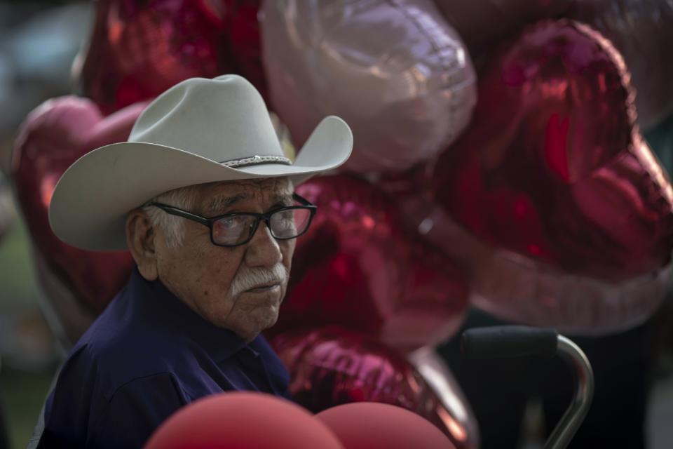An elderly man visits the memorial site for victims of the mass shooting at Robb Elementary School in the town square of Uvalde, Texas on Sunday, May 29, 2022. In a town as small as Uvalde, even those who didn't lose their own child lost someone. Some say now that closeness is both their blessing and their curse: they can lean on each other to grieve. But every single one of them is grieving. (AP Photo/Wong Maye-E)