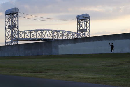 Tremone Wells, Hurricane Katrina survivor and Lower Ninth Ward resident, walks along the levee of the Industrial Canal one day before the ten year anniversary of Hurricane Katrina in New Orleans, Louisiana, August 28, 2015. REUTERS/Jonathan Bachman