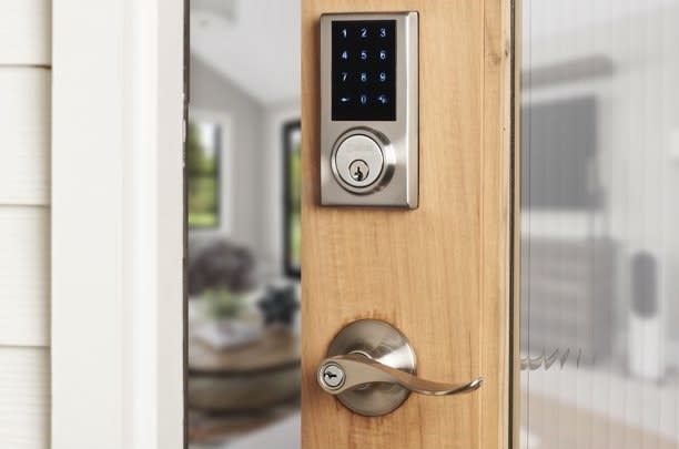 Smart lock keypad and handle on a wooden front door