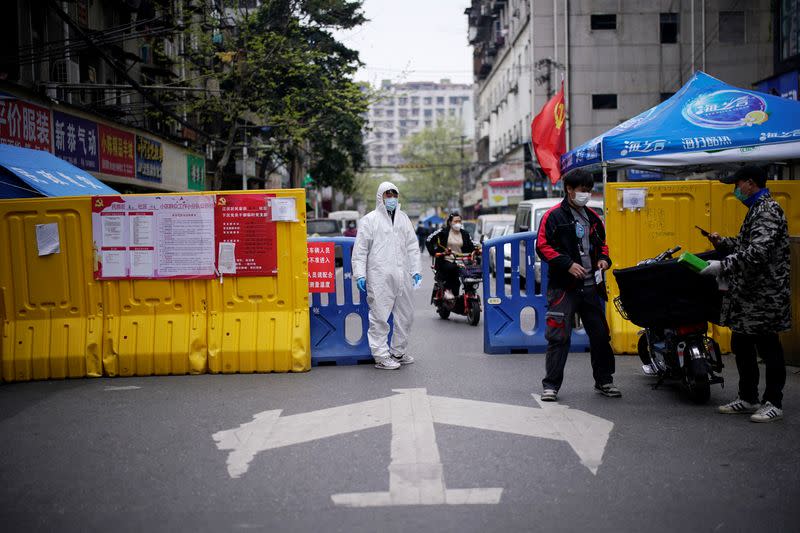 A check point of a community is seen at a residential area blocked by barriers in Wuhan