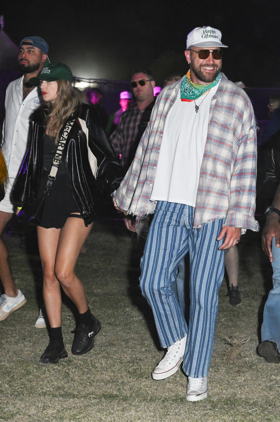 Taylor Swift wearing a patent leather jacket and Gucci sneakers with Travis Kelce at Neon Carnival held during the Coachella Music and Arts Festival on April 13, 2024 in Thermal, California.