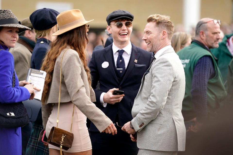 Ronan Keating (right) and son Jack Keating in the parade ring before the Ultima Handicap Chase during day one of the Cheltenham Festival at Cheltenham Racecourse in 2022 (PA)