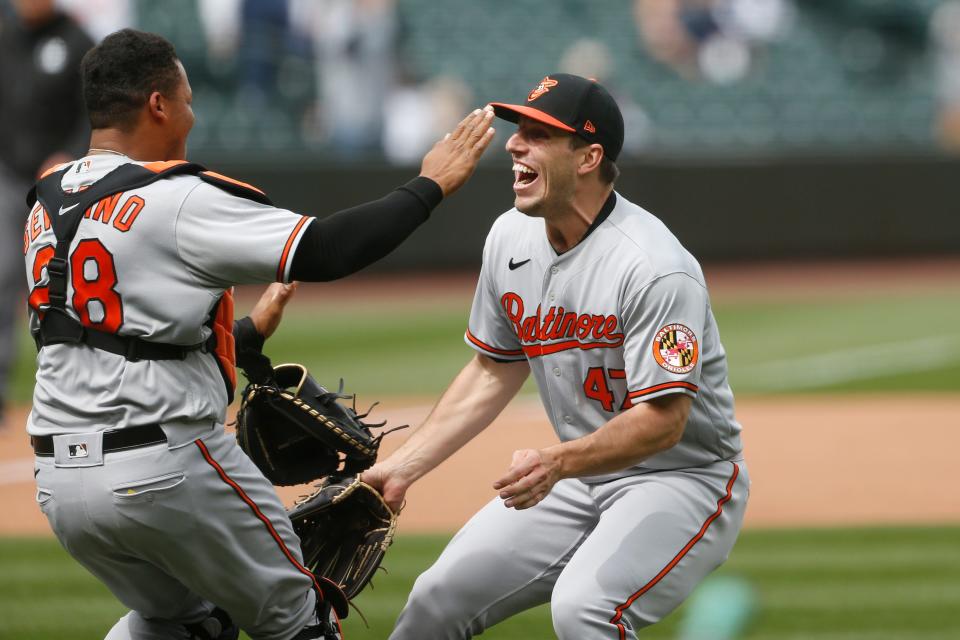 Orioles pitcher John Means, right, celebrates the final out of his no-hitter against the Mariners with catcher Pedro Severino.