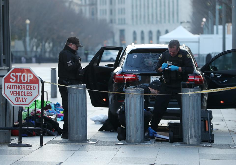 Members of the U.S. Secret Service examine belongings removed from a vehicle that tried to drive into a restricted area near the White House, on Nov. 21, 2019 in Washington.