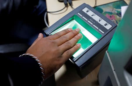 FILE PHOTO: A woman goes through the process of finger scanning for the Unique Identification (UID) database system, also known as Aadhaar, at a registration centre in New Delhi, January 17, 2018. REUTERS/Saumya Khandelwal/File photo