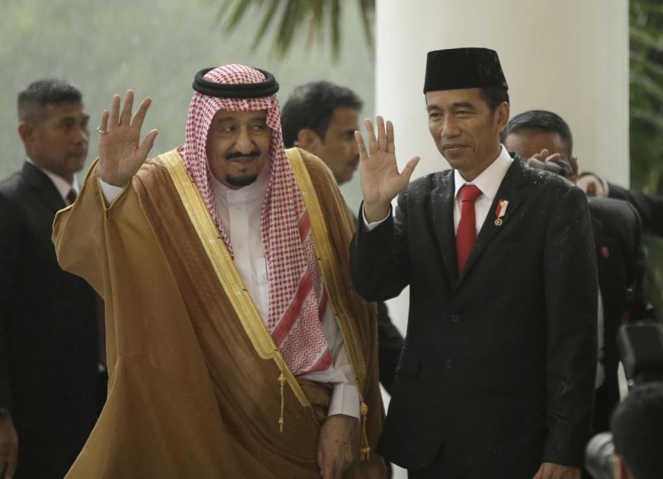 Saudi King Salman, left, and Indonesian President Joko Widodo wave at the media during their meeting at the presidential palace in Bogor, West Java, Indonesia, Wednesday, March 1, 2017. Salman arrived in the world's largest Muslim nation on Wednesday as a part of a multi-nation tour aimed at boosting economic ties with Asia. (AP Photo/Achmad Ibrahim, Pool)