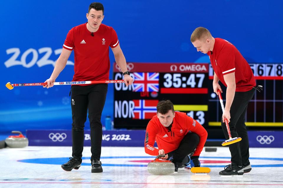 Great Britain's Bruce Mouat (centre) in action as Hammy McMillan (left) and Bobby Lammie sweep the ice (PA)