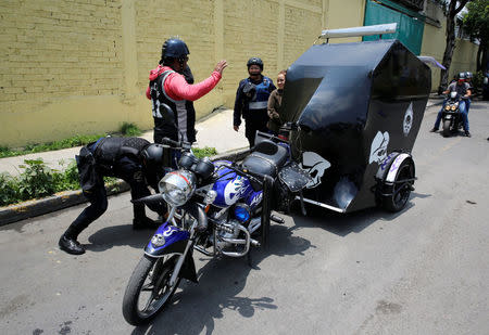 Police officers inspect a moto-taxi at a checkpoint after suspected gang members were killed on Thursday in a gun battle with Mexican marines in Mexico City, Mexico, July 21, 2017. REUTERS/Henry Romero