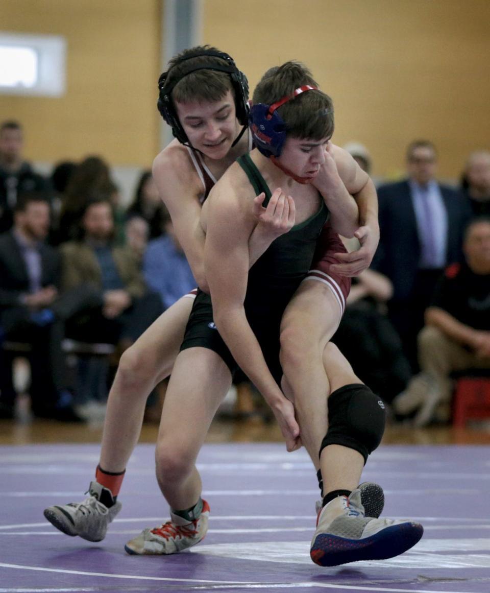 La Salle's Ryan Conlan and Jared Hood of Ponaganset tangle up on the mat in the 106-pound final.