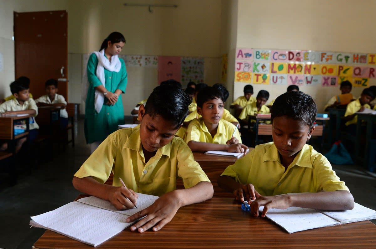 This photograph taken on 18 August 2017 shows young members of the Musahar community studying in a classroom at a school in Gonpura in Bihar (AFP via Getty Images)