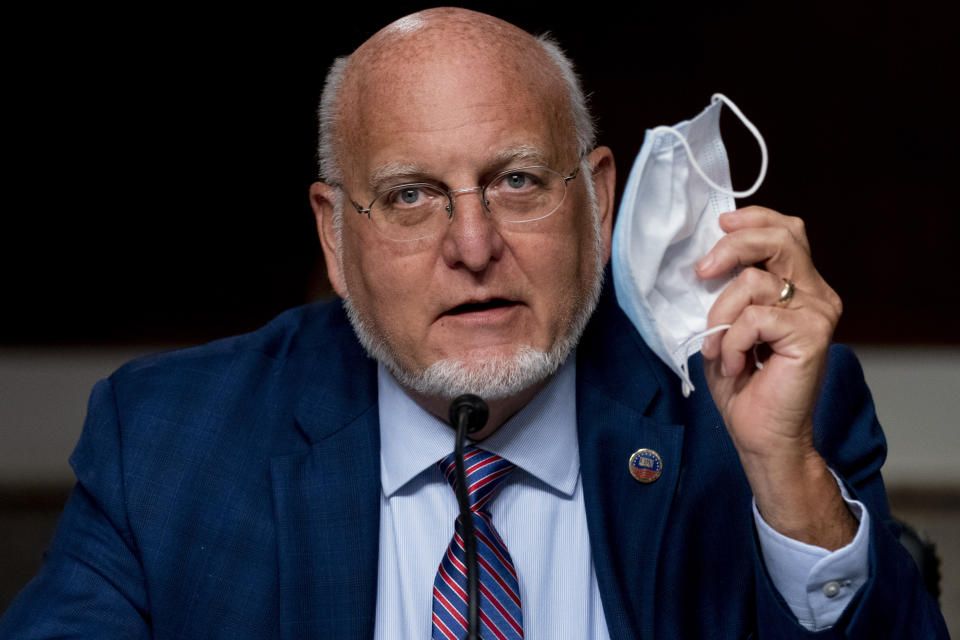 Centers for Disease Control and Prevention Director Dr. Robert Redfield holds up his mask as he speaks at a Senate Appropriations subcommittee hearing on a "Review of Coronavirus Response Efforts" on Capitol Hill, Wednesday, Sept. 16, 2020, in Washington. (AP Photo/Andrew Harnik, Pool)