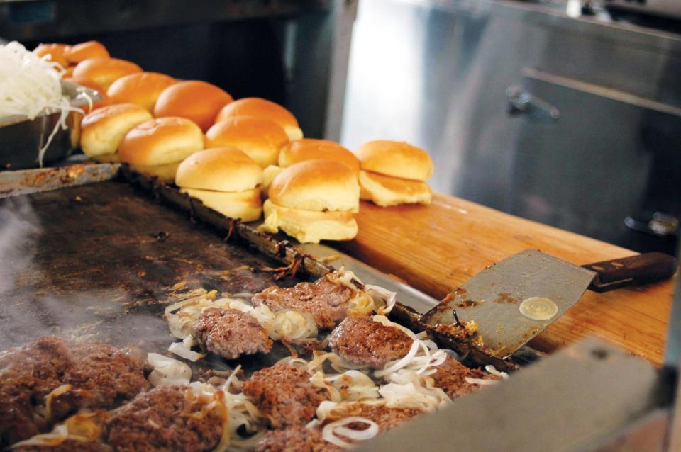 The White Manna Hamburgers restaurant in Hackensack was originally a booth at the Worlds Fair in Queens in 1939. It was moved from Queens to Hackensack in 1946. Some rumors say that White Castle was based on this burger joint. Here burgers cook on the grill.  Photo: Christopher Sadowski