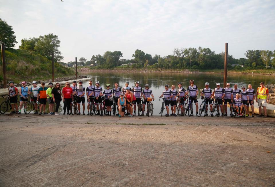 Members of the RAGBRAI route inspection team begin their Day 1 ride on Sunday with a tire dip in the Missouri River at Sioux City.