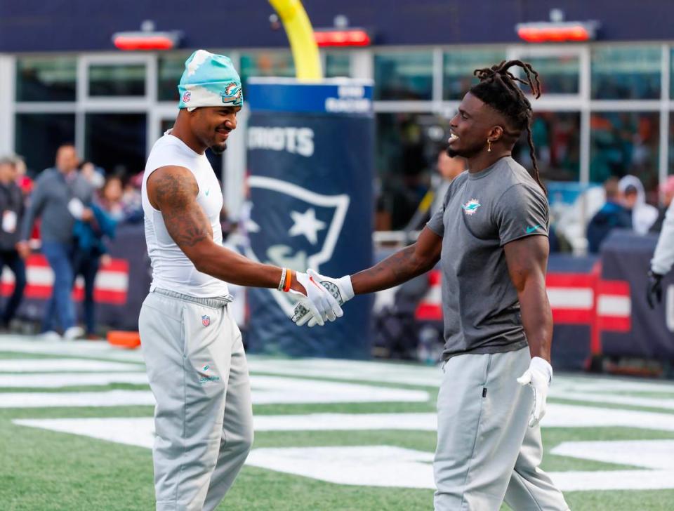 Miami Dolphins wide receiver Jaylen Waddle (17) shake hands with teammate Tyreek Hill (10) during pregame warmups before the start of an NFL football game against the New England Patriots against the at Gillette Stadium on Sunday, January 1, 2023 in Foxborough, MA.