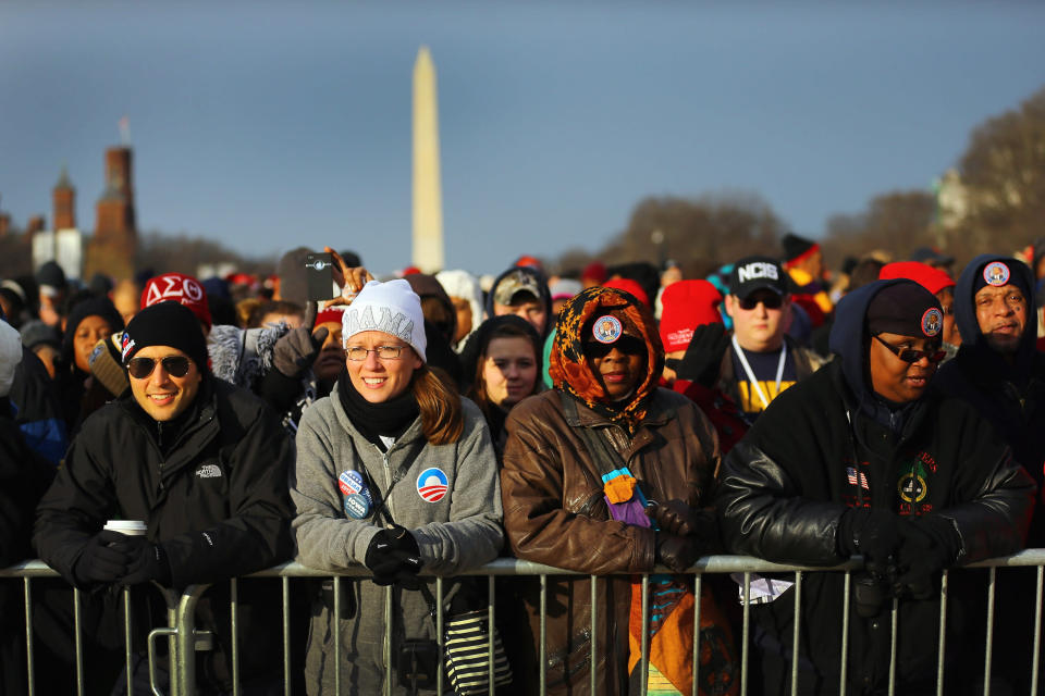 People gather near the U.S. Capitol building on the National Mall for the Inauguration ceremony on January 21, 2013 in Washington, DC. U.S. President Barack Obama will be ceremonially sworn in for his second term today. (Photo by Joe Raedle/Getty Images)