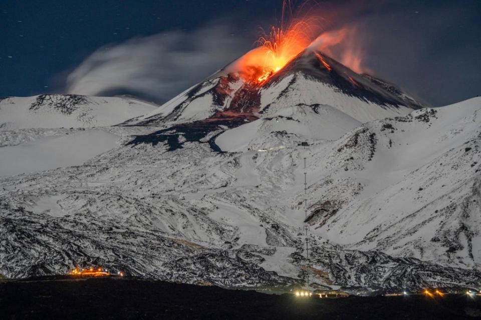 Mount Etna erupts, scattering ashes around its populated surroundings.