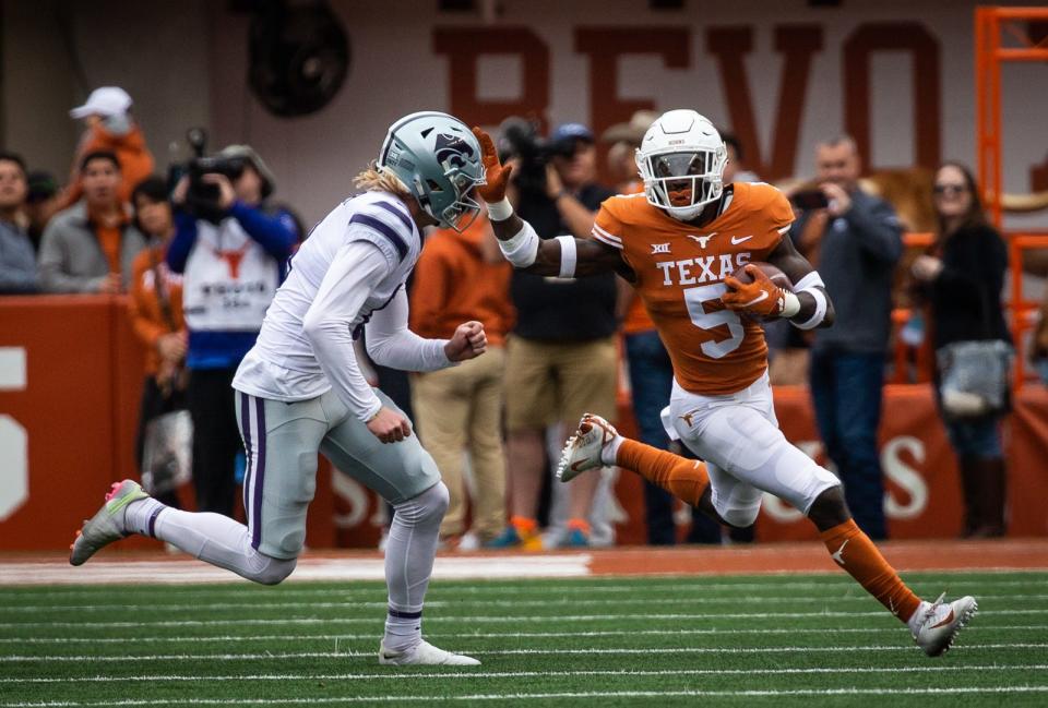 Texas running back Bijan Robinson tries to get around a Kansas State defender at Royal-Memorial Stadium in November. Robinson should eclipse the 2,000-yard career mark early this fall.