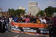 Members of Combined People's Movement, a collective of trade union and civil society organisations, shout anti-government slogans and march to the site of a protest rally in Colombo, Sri Lanka, Thursday, Oct. 27, 2022. (AP Photo/Eranga Jayawardena)