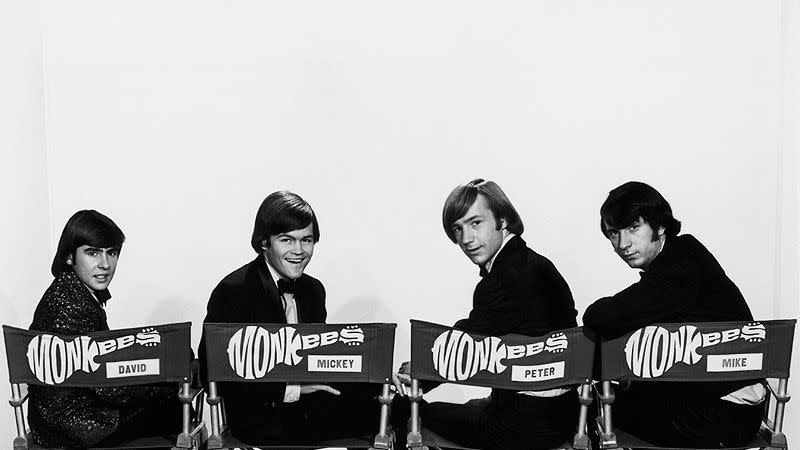 (Original Caption) In four director chairs are seated members of the infamous group,The Monkees. David Jones, Mickey Dolenz, Peter Tork and Michael Nesmith. They are smiling while seated head over shoulder.