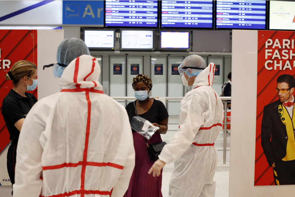 A passenger arrives to be tested with the COVID-19 test, at the Roissy Charles de Gaulle airport, outside Paris, Saturday, Aug. 1, 2020. Travelers entering France from 16 countries where the coronavirus is circulating widely are having to undergo virus tests upon arrival at French airports and ports.(AP Photo/Thibault Camus)
