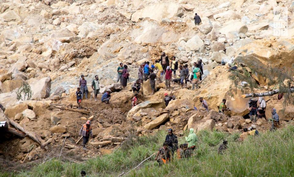 PHOTO: People clear an area at the site of a landslide in Yambali village, Enga Province, Papua New Guinea, May 27, 2024.    (Undp Papua New Guinea/via Reuters)