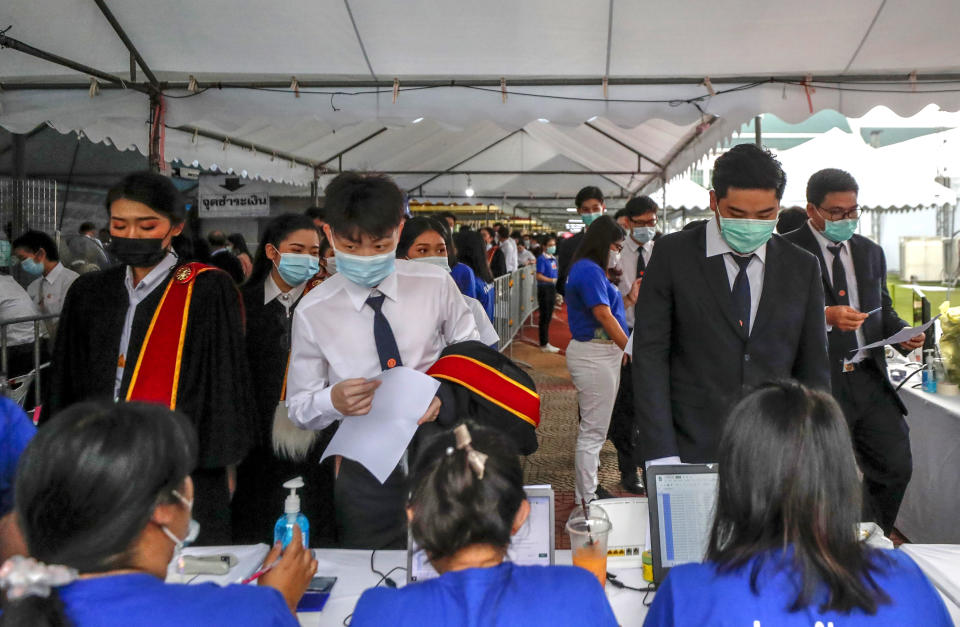 University students arrive for their graduation ceremony at the Thammasat University, Friday, Oct. 30, 2020, in Bangkok, Thailand. (AP Photo/Sakchai Lalit)