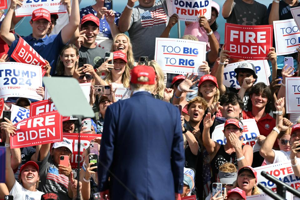 Supporters of former president and Republican presidential candidate Donald Trump cheer as he arrives to speak at a campaign event in Racine, Wisconsin, on June 18, 2024.