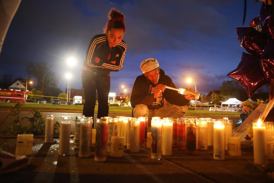 Mourners light candles at a makeshift memorial outside of Tops market in Buffalo, New York where 10 Black people were shot dead by a teenager (Getty Images)