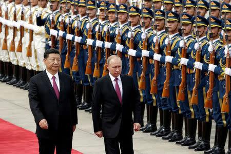 Chinese President Xi Jinping and Russian President Vladimir Putin attend a welcome ceremony outside the Great Hall of the People in Beijing, China June 8, 2018. REUTERS/Jason Lee