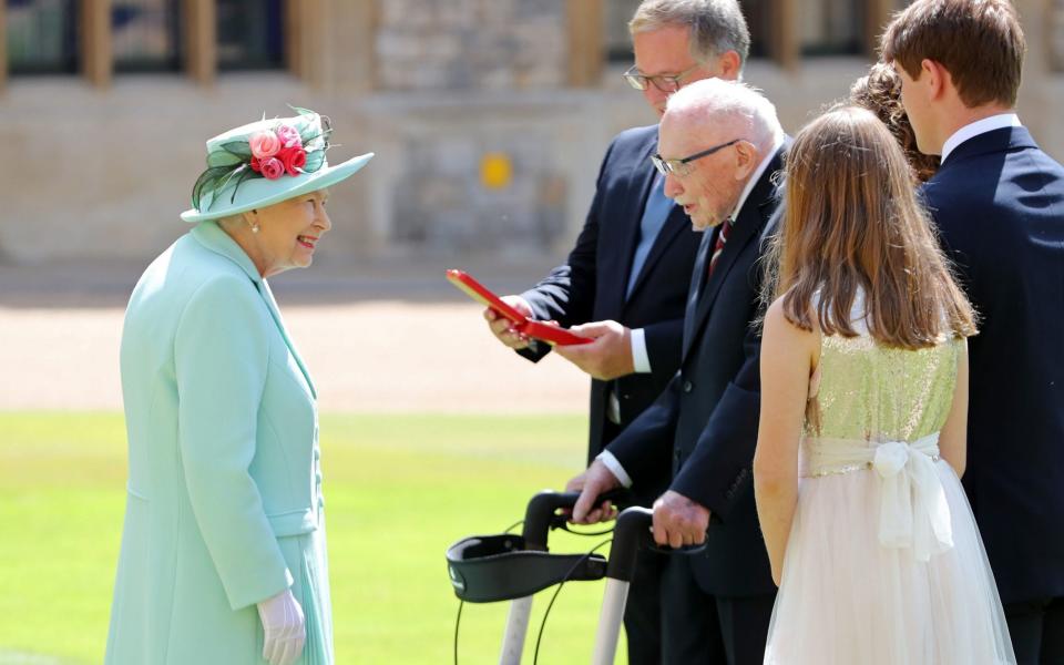 Queen Elizabeth II talking Captain Sir Thomas Moore and his family after awarding his knighthood during a ceremony at Windsor Castle. -  Chris Jackson/PA Wire