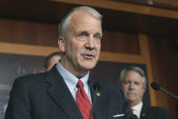 Sen. Dan Sullivan, R-Alaska, left, with several of his Senate colleagues discuss during a news conference how the Biden administration's upcoming sanctions on America's ability to produce oil and critical minerals weaken America's energy security and embolden enemies on Capitol Hill Thursday, April 18, 2024, in Washington. (AP Photo/Mariam Zuhaib)