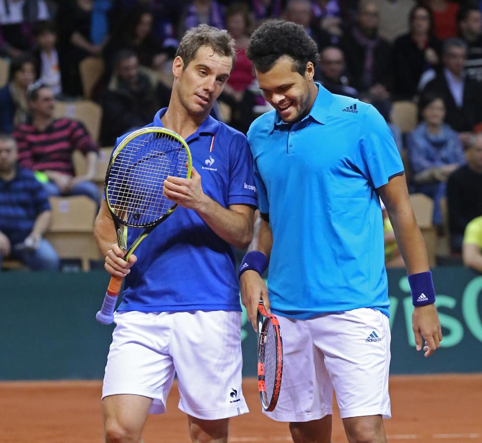 French players Jo-Wilfried Tsonga and Richard Gasquet, left, talk during their doubles match against Australian players Lleyton Hewitt and Chris Guccione in the first round of the Davis Cup between France and Australia, in La Roche sur Yon, western France, Saturday Feb. 1, 2014. (AP Photo/Remy de la Mauviniere)