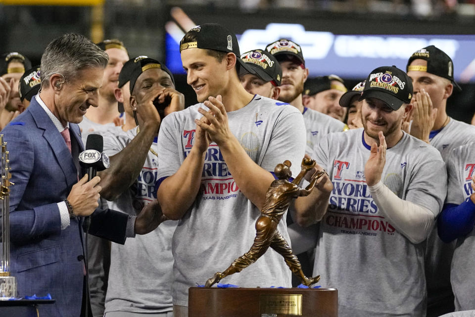 Texas Rangers shortstop Corey Seager stands by the trophy after Game 5 of the baseball World Series against the Arizona Diamondbacks Wednesday, Nov. 1, 2023, in Phoenix. The Rangers won 5-0 to win the series 4-1.(AP Photo/Brynn Anderson)