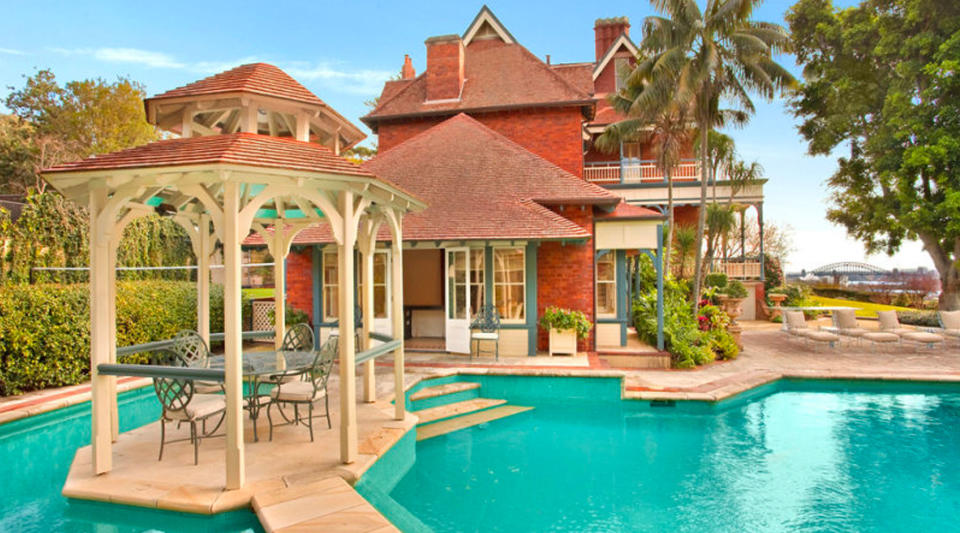 A large pool divided from the ample spa by a gazebo. 