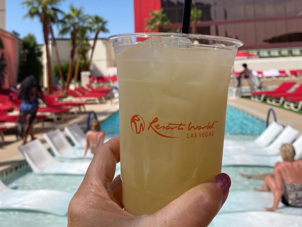 Hand holding iced drink at a pool resort in Vegas