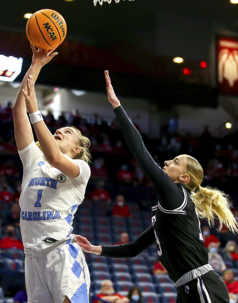 North Carolina guard Alyssa Ustby (1) shoots in front of Stephen F. Austin guard Stephanie Visscher (13) during a first-round game in the NCAA women's college basketball tournament Saturday, March 19, 2022, in Tucson, Ariz. (Rebecca Sasnett/Arizona Daily Star via AP)