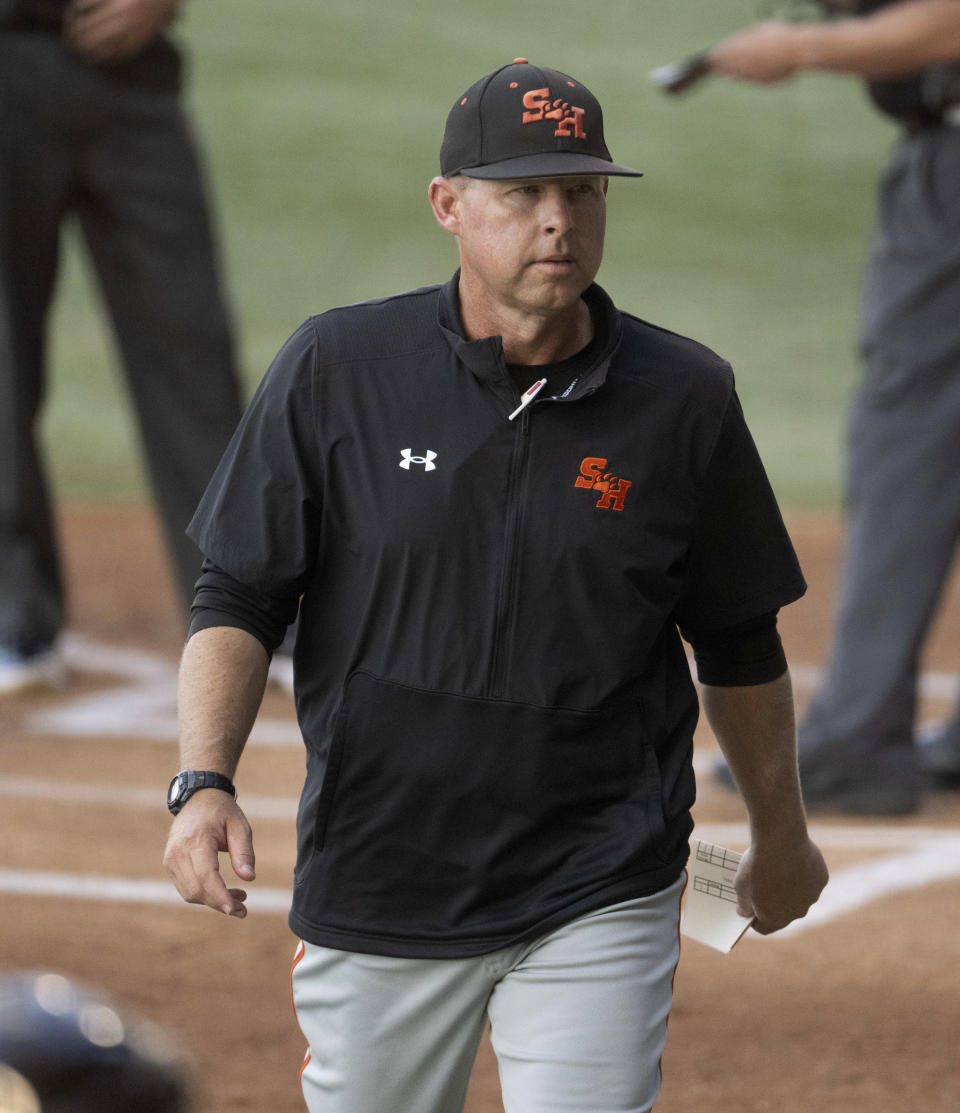 Sam Houston State head coach Jay Sirianni returns to the dugout after meeting with officials before the first pitch against Oregon State in an NCAA college baseball tournament regional game Friday, June 2, 2023, in Baton Rouge, La. (Hilary Scheinuk/The Advocate via AP)
