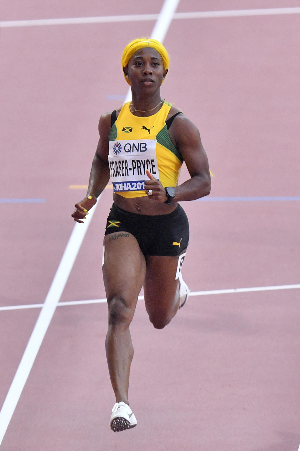 Shelly-Ann Fraser-Pryce, of Jamaica, competes in in a women's 100 meter race heat during the World Athletics Championships in Doha, Qatar, Saturday, Sept. 28, 2019. (AP Photo/Martin Meissner)