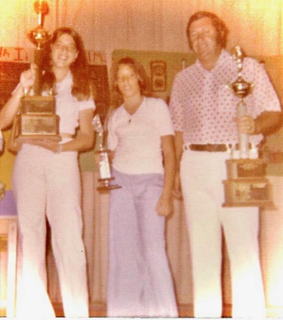 Diana Hernandez, middle, is in sixth grade at Leroy D. Fienberg Elementary School in Miami Beach in the 1970s when she receives an award from PE teacher Arnie Notkin, along with her sister Silvia. Notkin and his wife Myriam were among those missing Thursday after the Surfside condo tower collapsed.