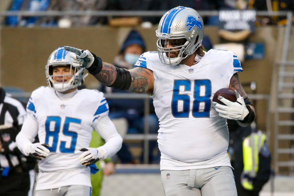 Detroit Lions offensive tackle Taylor Decker celebrates after catching a touchdown pass against the Seattle Seahawks during the third quarter at Lumen Field in Seattle, Jan. 2, 2022.