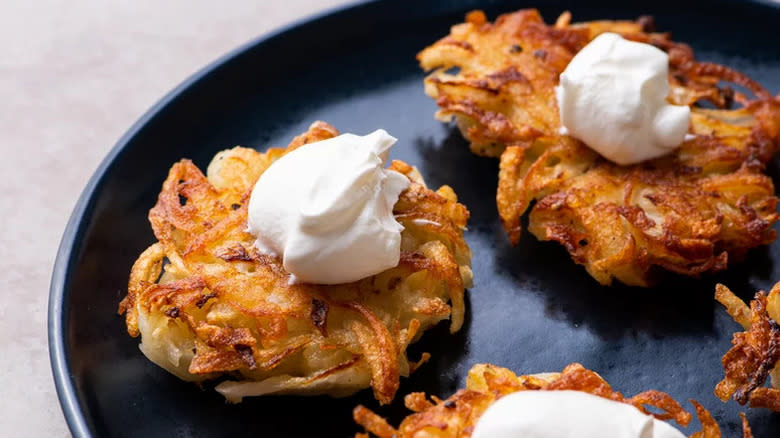 Latkes topped with sour cream
